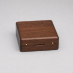closed walnut coin presentation box with rounded corners