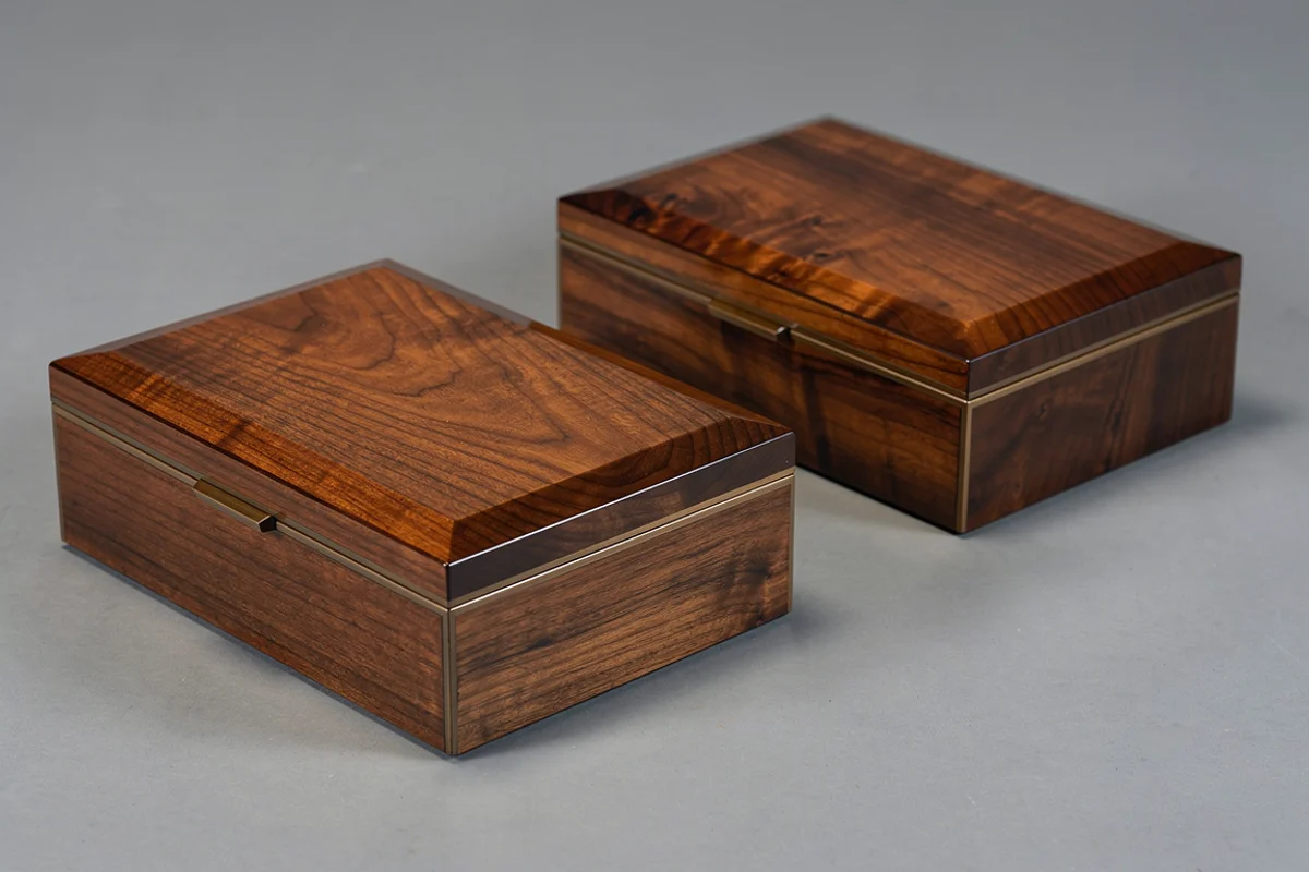 Two finished wood-grain presentation boxes with their lid seams visible